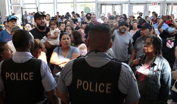Cicero police block the entrance as dozens of residents demand to be allowed in to speak out at the Cicero Town Hall over recent flooding, July 11, 2023. 