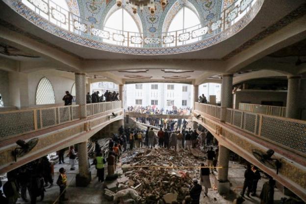 Rescue workers look for survivors in a Mosque strewn with rubble.