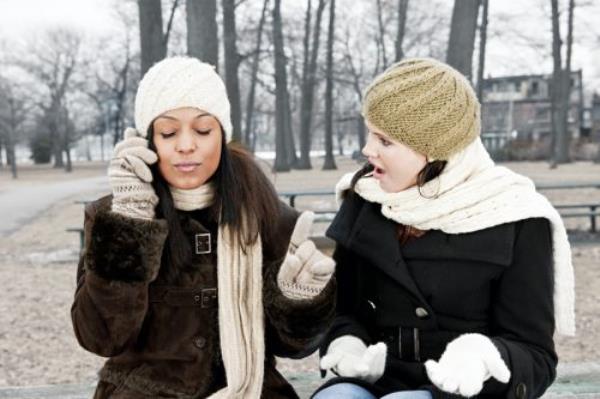 woman balking at her friend's rude behavior outdoors in winter