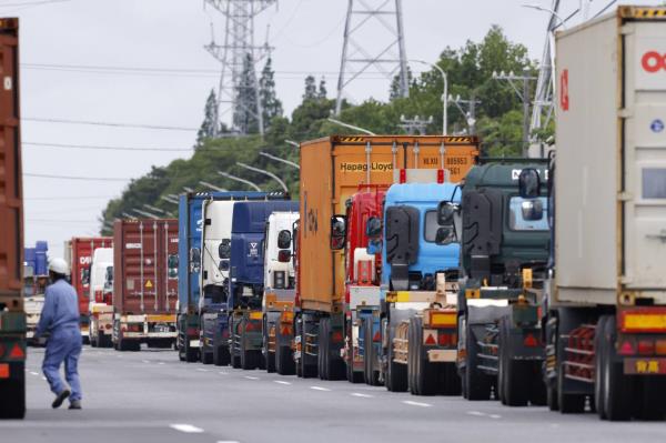 Cargo trucks line up at a co<em></em>ntainer terminal in the Port of Nagoya in Tobishima, Aichi Prefecture, on Wednesday. | KYODO