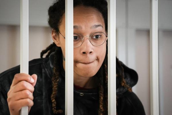 FILE - WNBA star and two-time Olympic gold medalist Brittney Griner speaks to her lawyers standing in a cage at a court room prior to a hearing, in Khimki just outside Moscow, Russia, Tuesday, July 26, 2022. 
