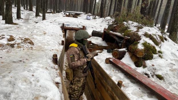 A Ukrainian soldier on duty near the border with Belarus.   Ukraine claims it has built an elaborate system of trenches and other defences to deter a possible repeat attack from Russia.