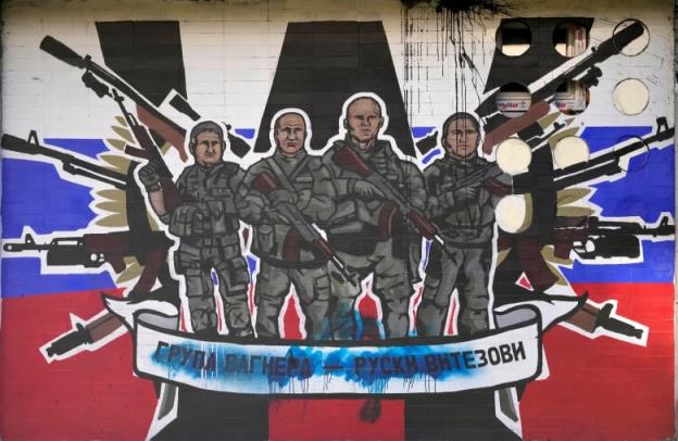 A mural of four soldiers holding guns.