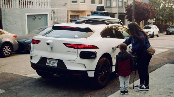 A Waymo self-driving car, like this one seen picking up passengers, hit a small dog that ran into a San Francisco street, the company says. The dog died.